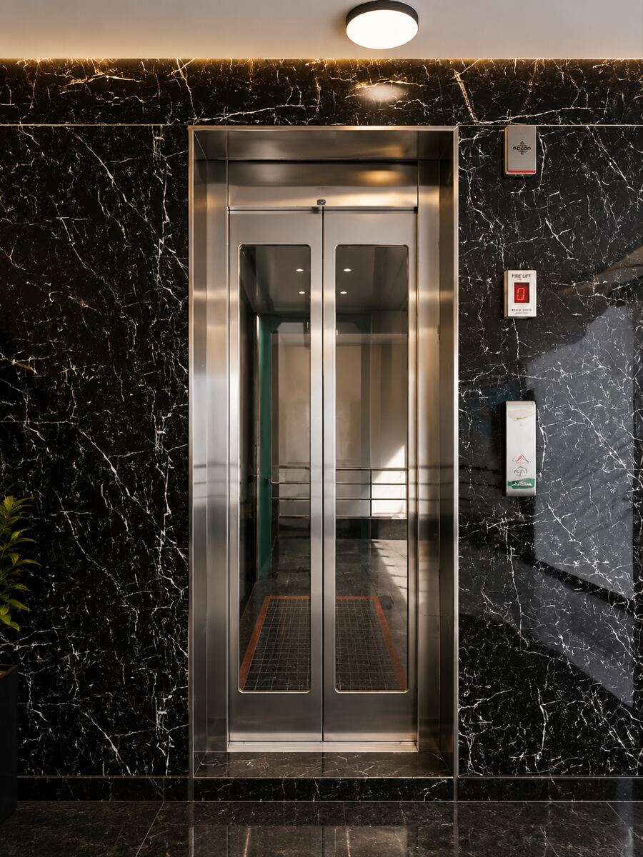 Elevator cabin with full-height mirror and marble side walls