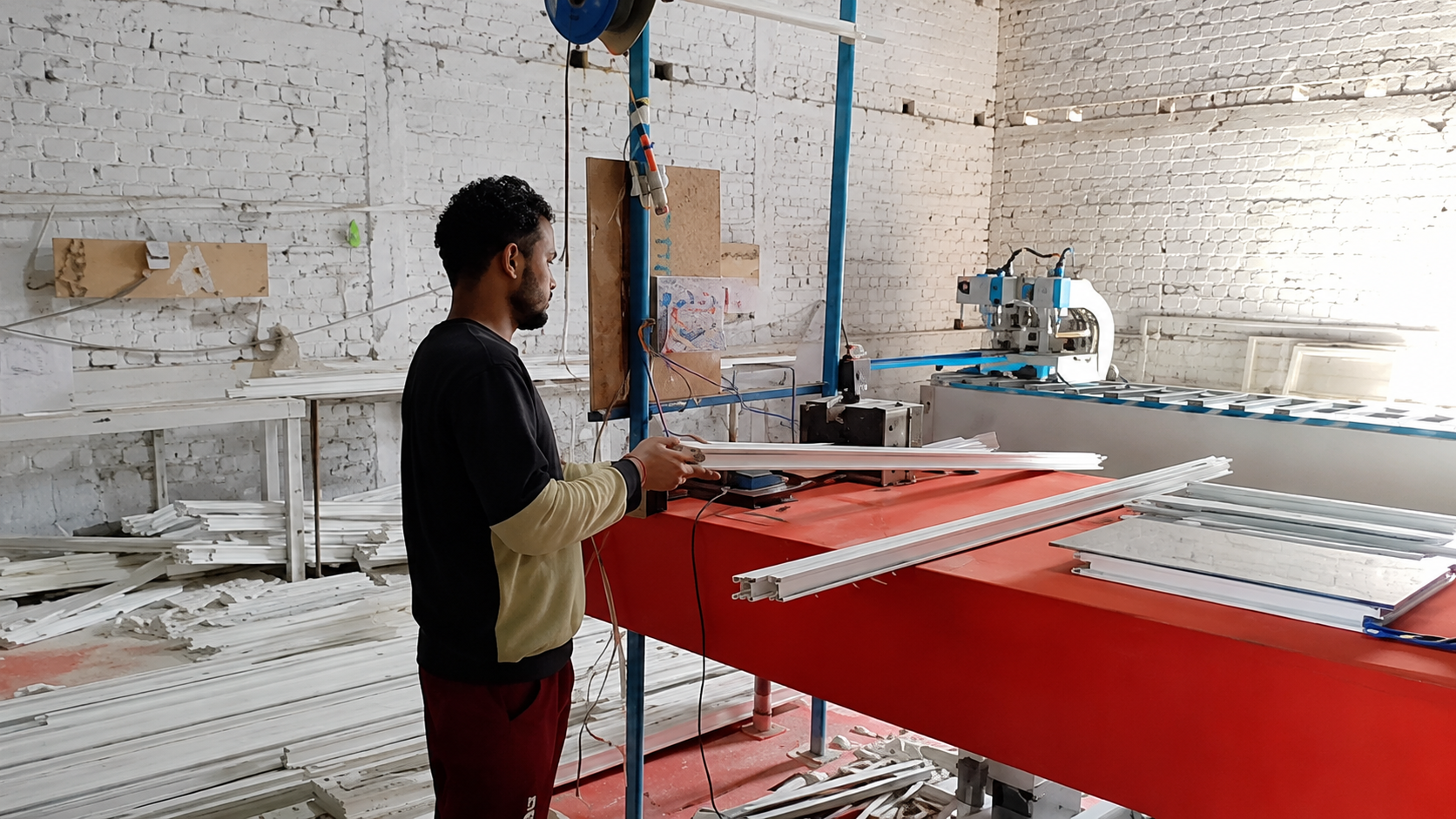 Sharique Engineering technician cutting uPVC profile on the fabrication table